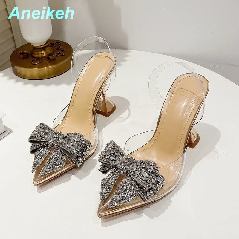 Aneikeh 2026 Fashion Crystal Sequined Bowknot Women Pumps Sexy Pointed Toe High Heels PVC Transparent Sandals Wedding Prom Shoes