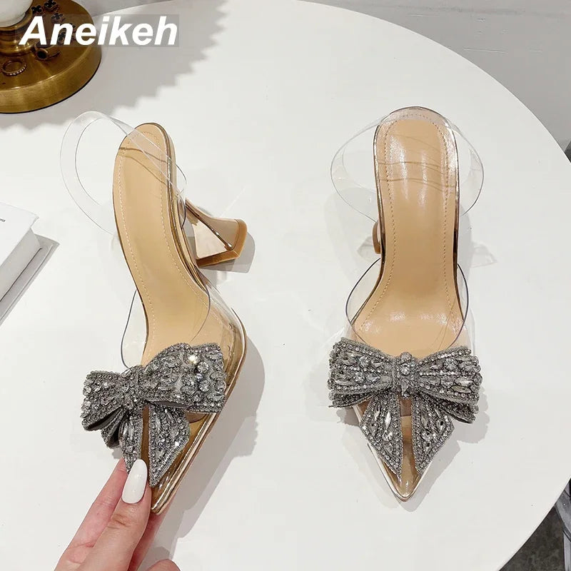 Aneikeh 2026 Fashion Crystal Sequined Bowknot Women Pumps Sexy Pointed Toe High Heels PVC Transparent Sandals Wedding Prom Shoes